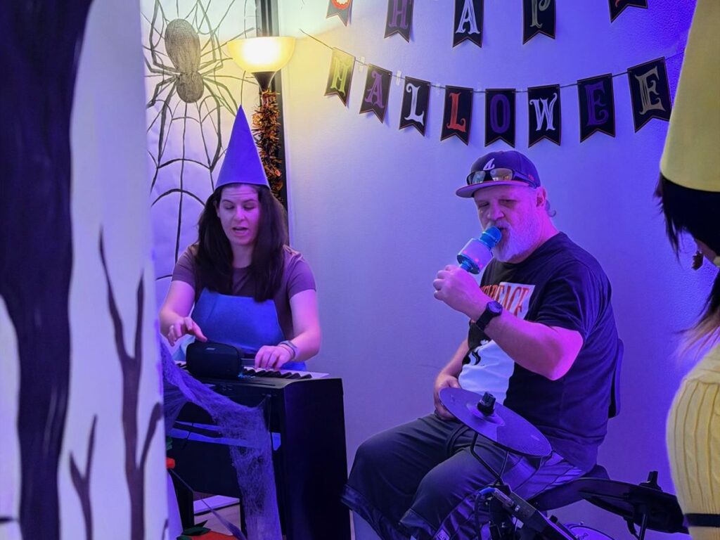 Adult musicians jamming on keyboard and microphone at the OC Music Services studio