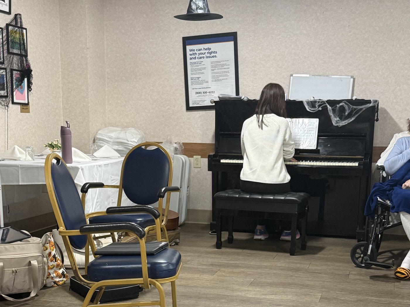 An OC Music Services musician playing piano for residents at an assisted living community