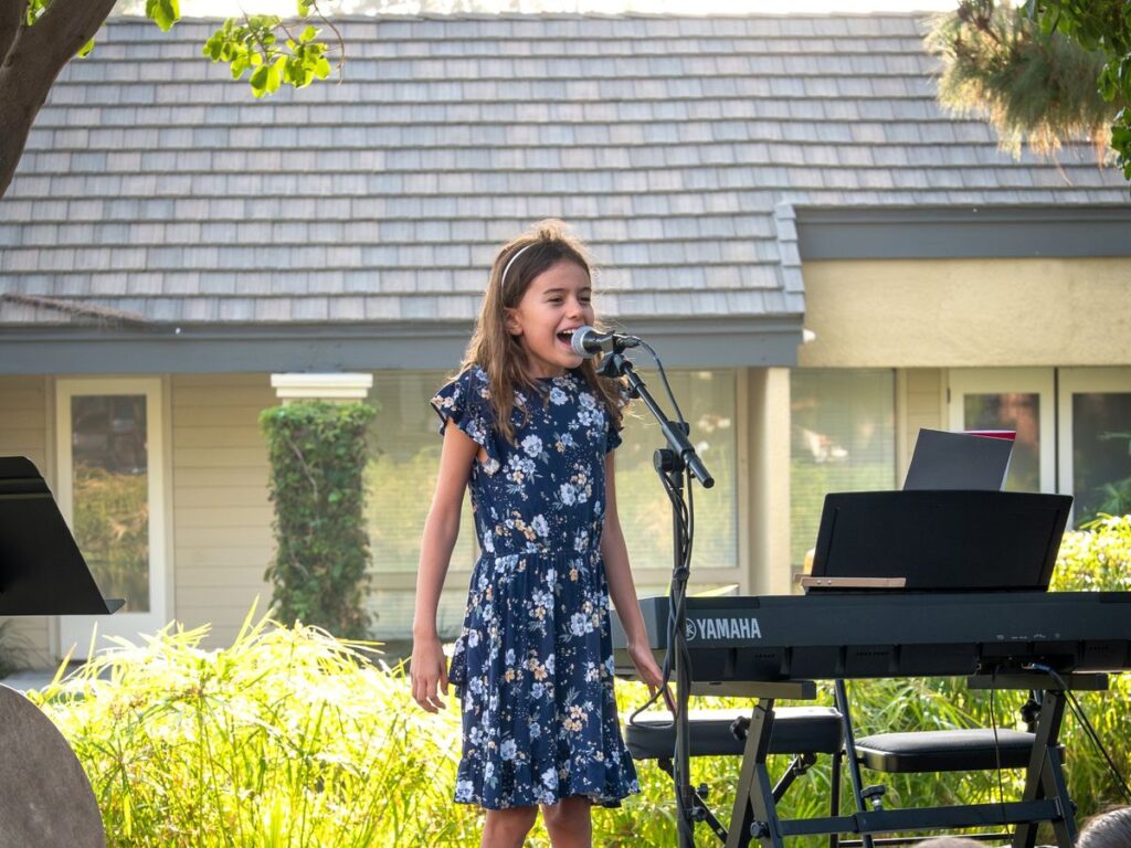 A young student singing at an OC Music Services recital